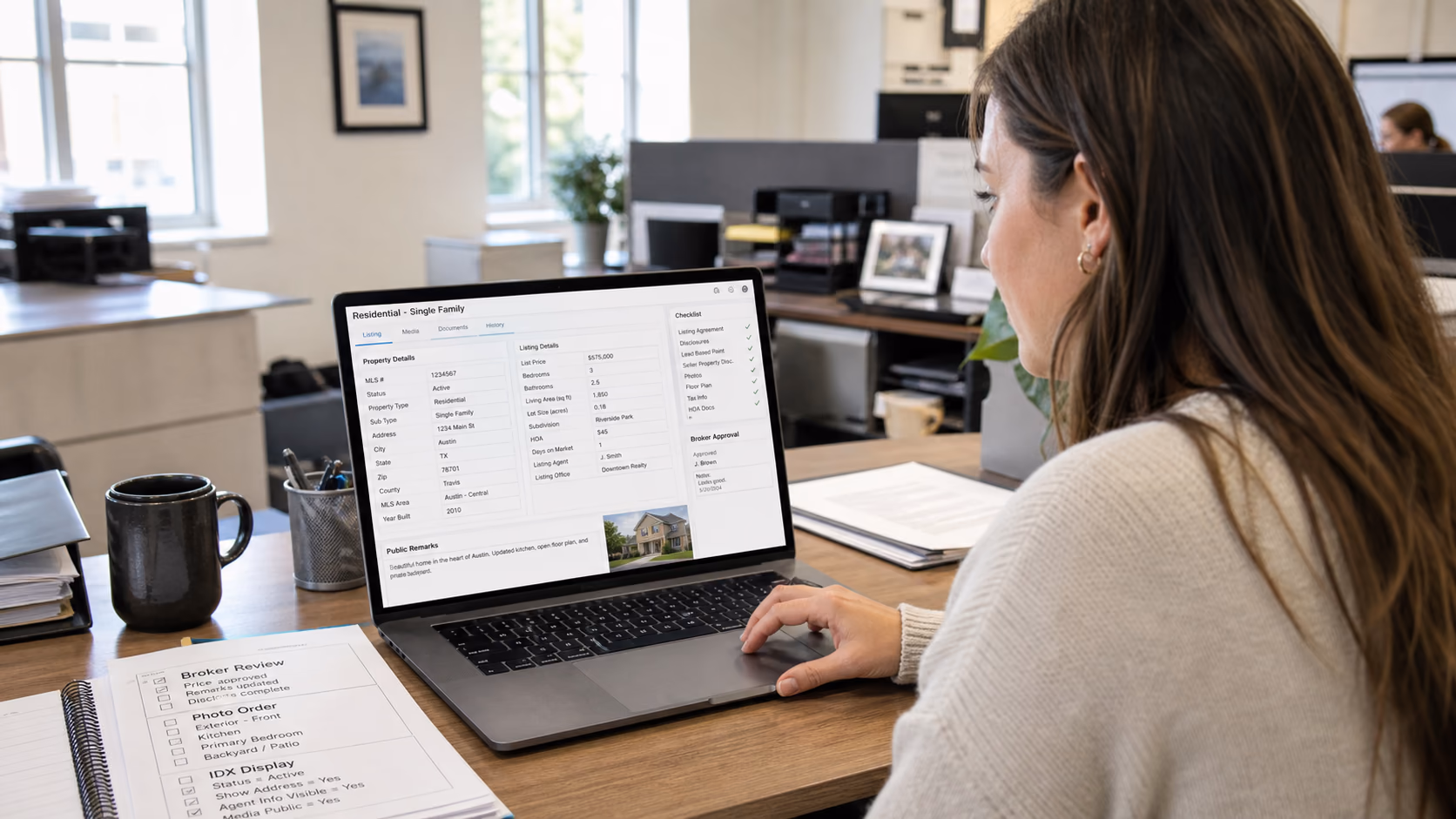 A US real estate operations coordinator reviewing MLS listing fields, broker approval notes, photo order, and IDX display requirements on a laptop in a brokerage office